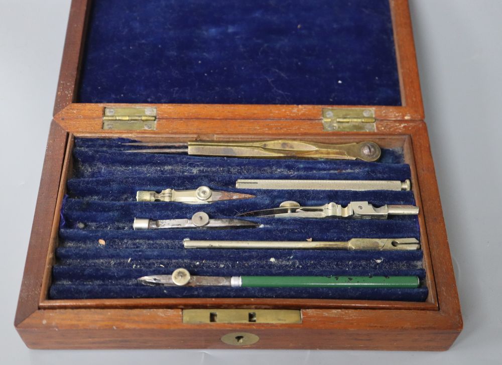 A mahogany box containing drawing instruments